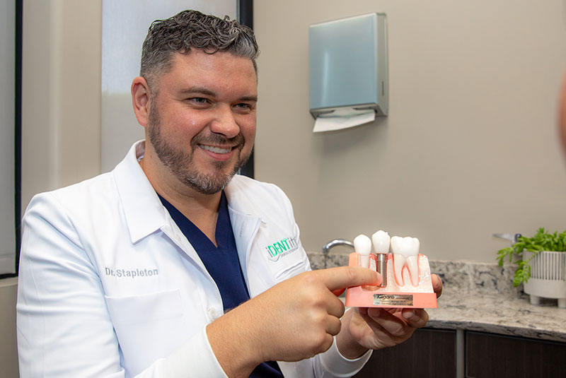 Dr. stapelton holding single dental implant